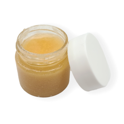 a small jar of honey colored lip scrub