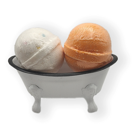 a small white replica bath tub with legs containing two bath bombs