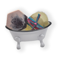 a small white replica bath tub with legs containing an assortmet of soaps