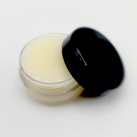an open jar of lemon color lip scrub